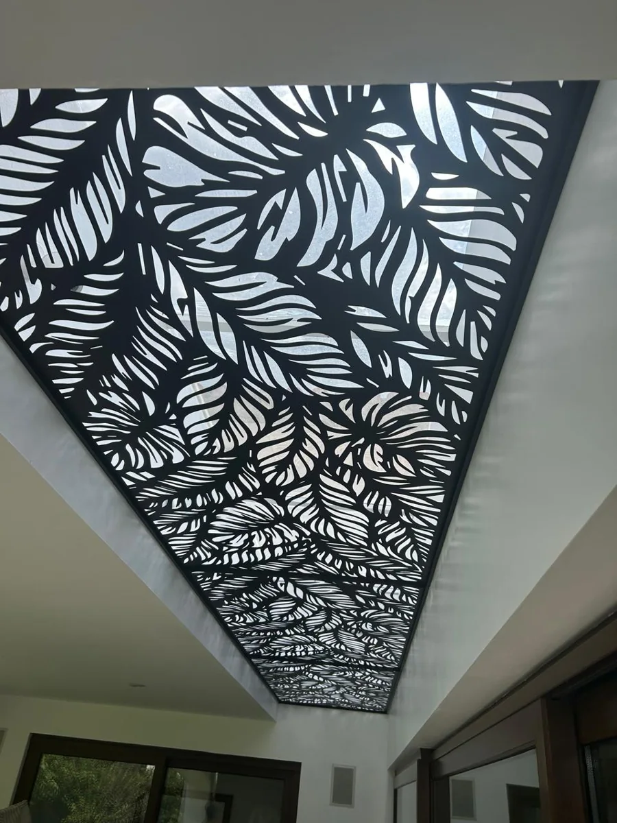 Architectural metal panel with a leaf pattern in an interior space